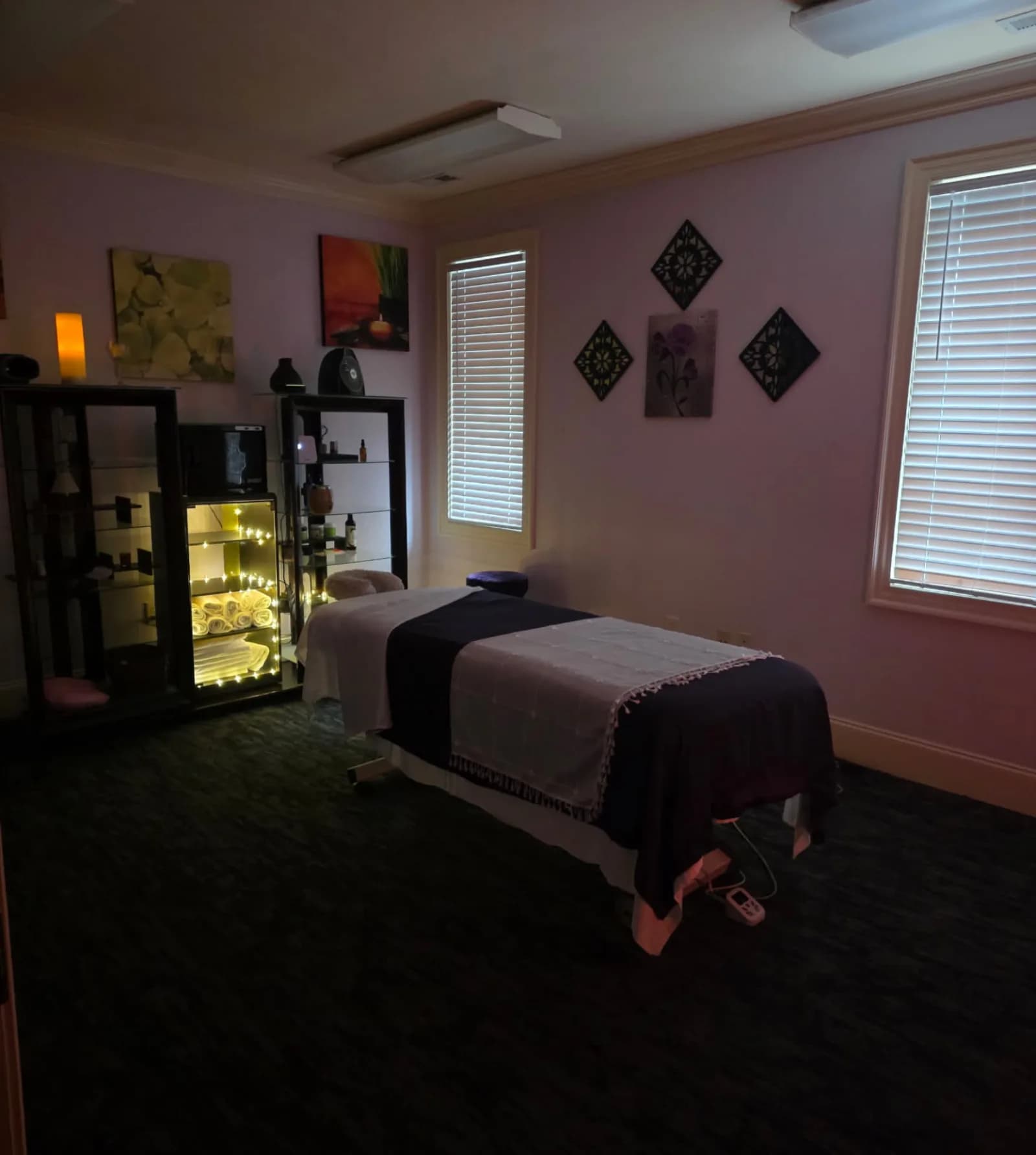 Hanztastic massage room with prepared treatment tables, clean linens and organized cabinetry
